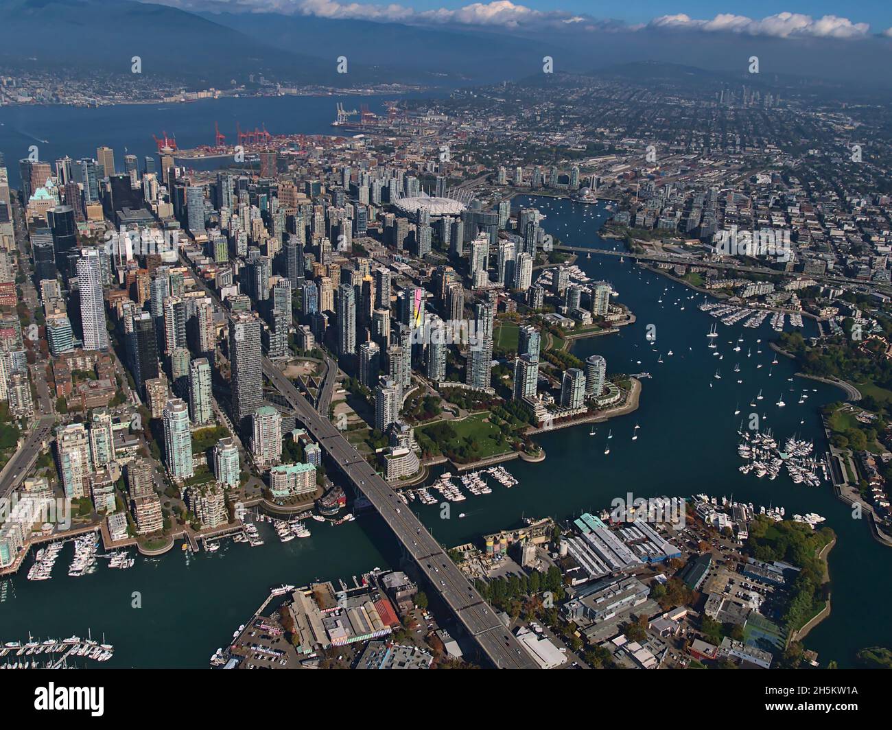 Stunning aerial view of Vancouver downtown, British Columbia, Canada with False Creek bay, marinas, stadium and skyline with tall skyscrapers. Stock Photo