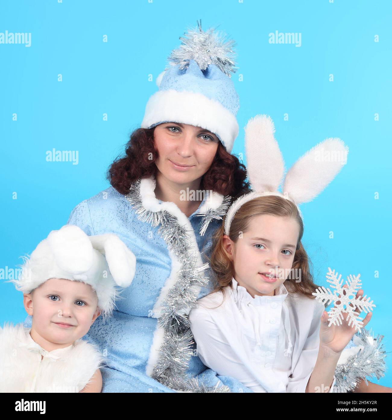 pretty young Snow Maiden with her cute little hares Stock Photo