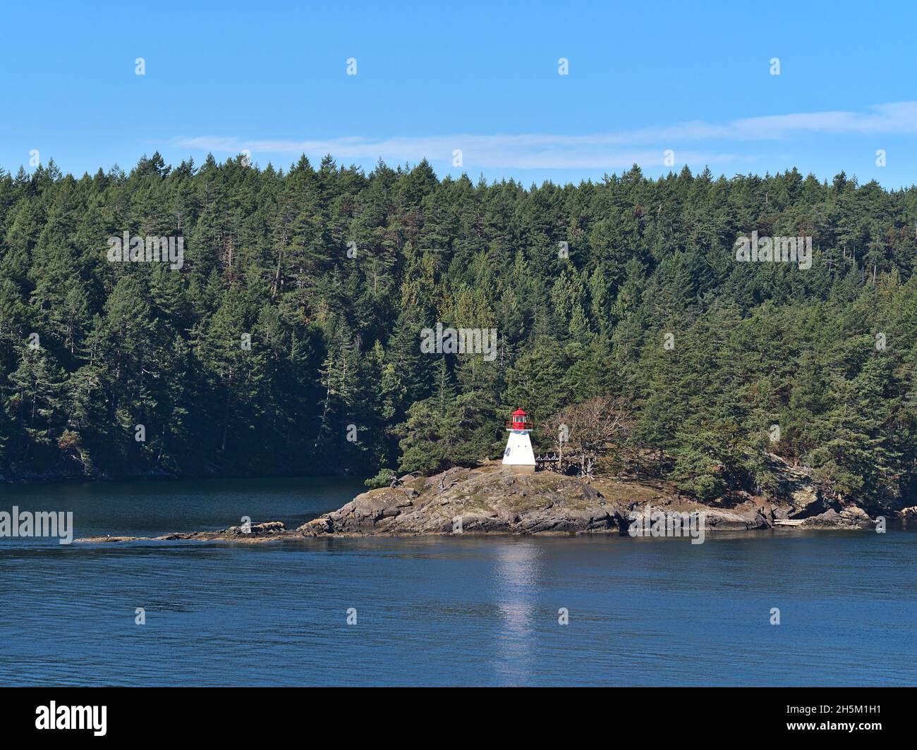 Beautiful view of Portlock Point Lighthouse on Prevost Island, part of the Gulf Islands in British Columbia, Canada in the Salish Sea on sunny day. Stock Photo