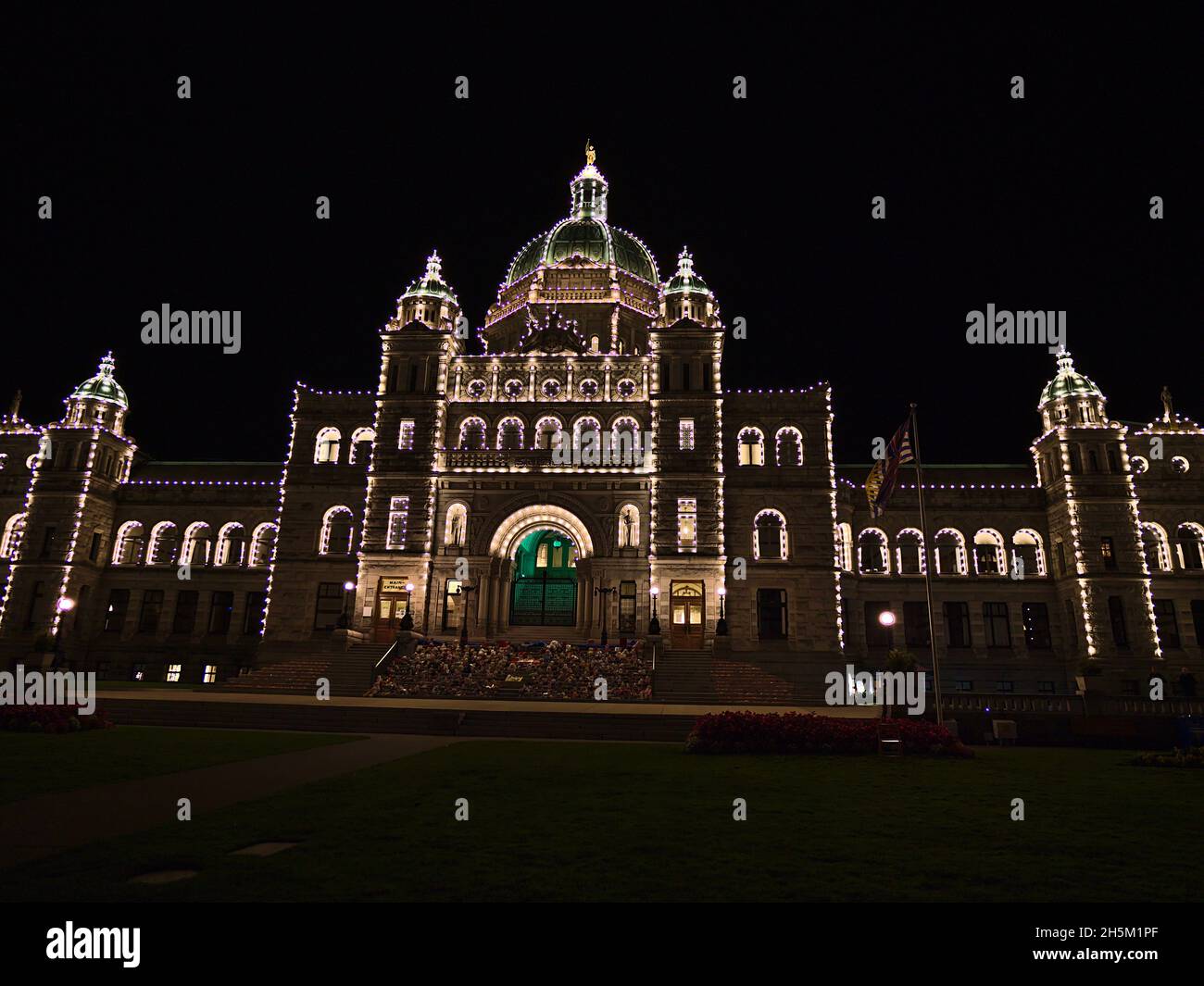 Illuminated entrance of impressive British Columbia Parliament Buildings in neo-baroque style with lights on facade in Victoria downtown, Canada. Stock Photo