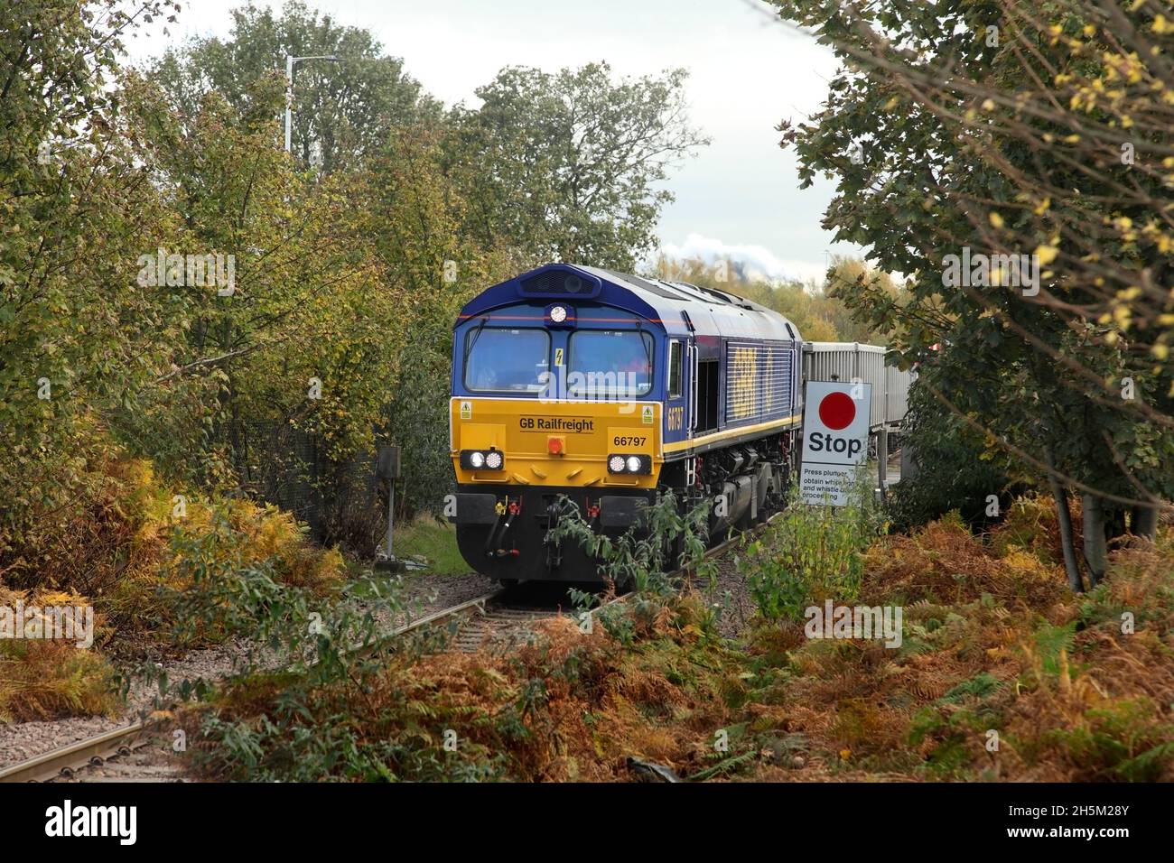 GBRF Class 66 loco 66797 hauling the 0410 Renwick Rd (Barking) to Scunthorpe Roxby Gullet service past Dawes Lane LC on 9/11/21. Stock Photo