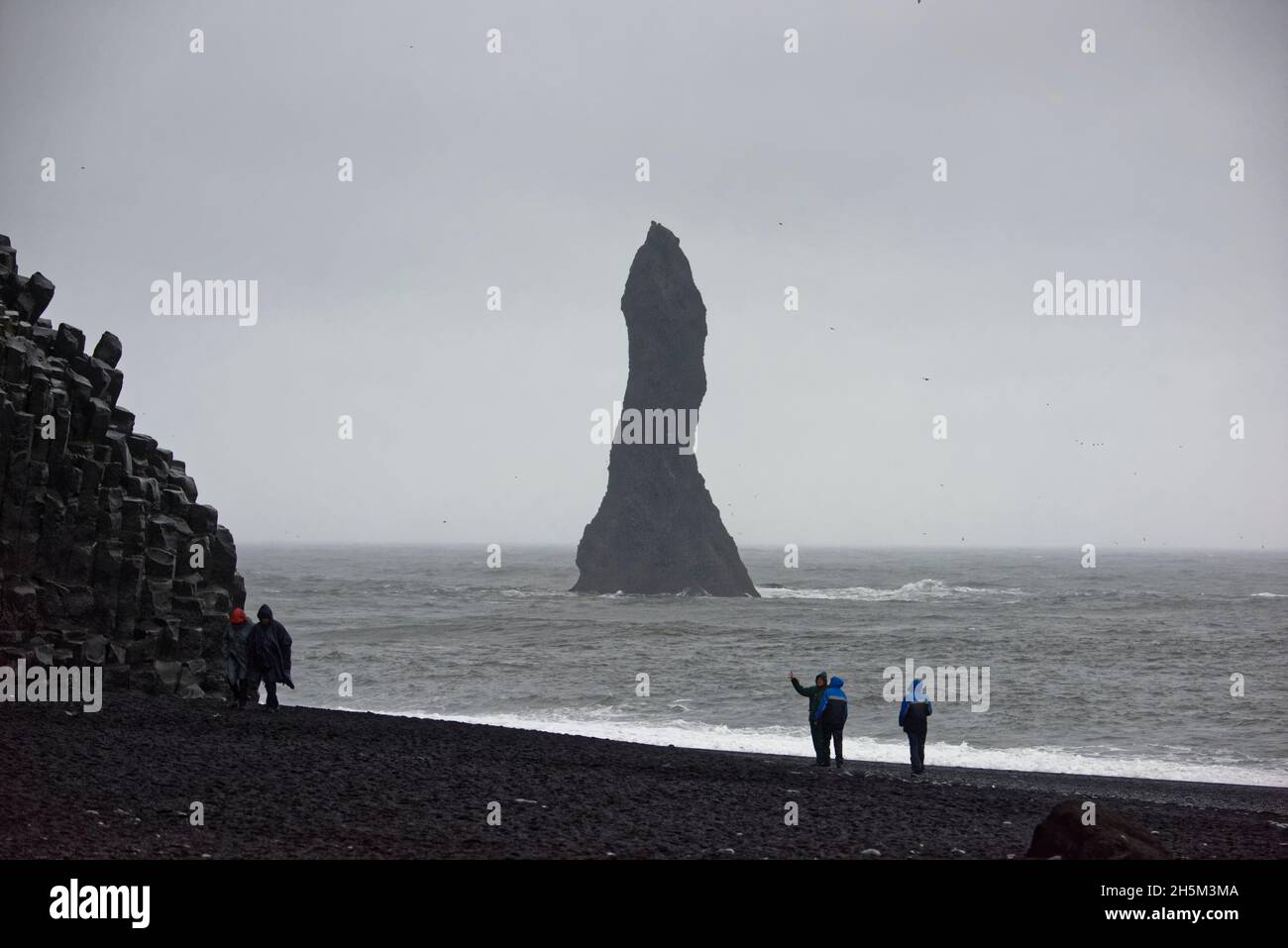 The Reynisdrangar basalt sea stacks and the Reynisfjara black sand ...