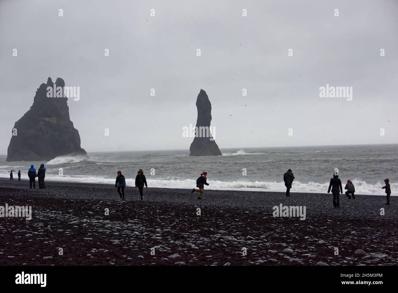 The Reynisdrangar basalt sea stacks and the Reynisfjara black sand ...