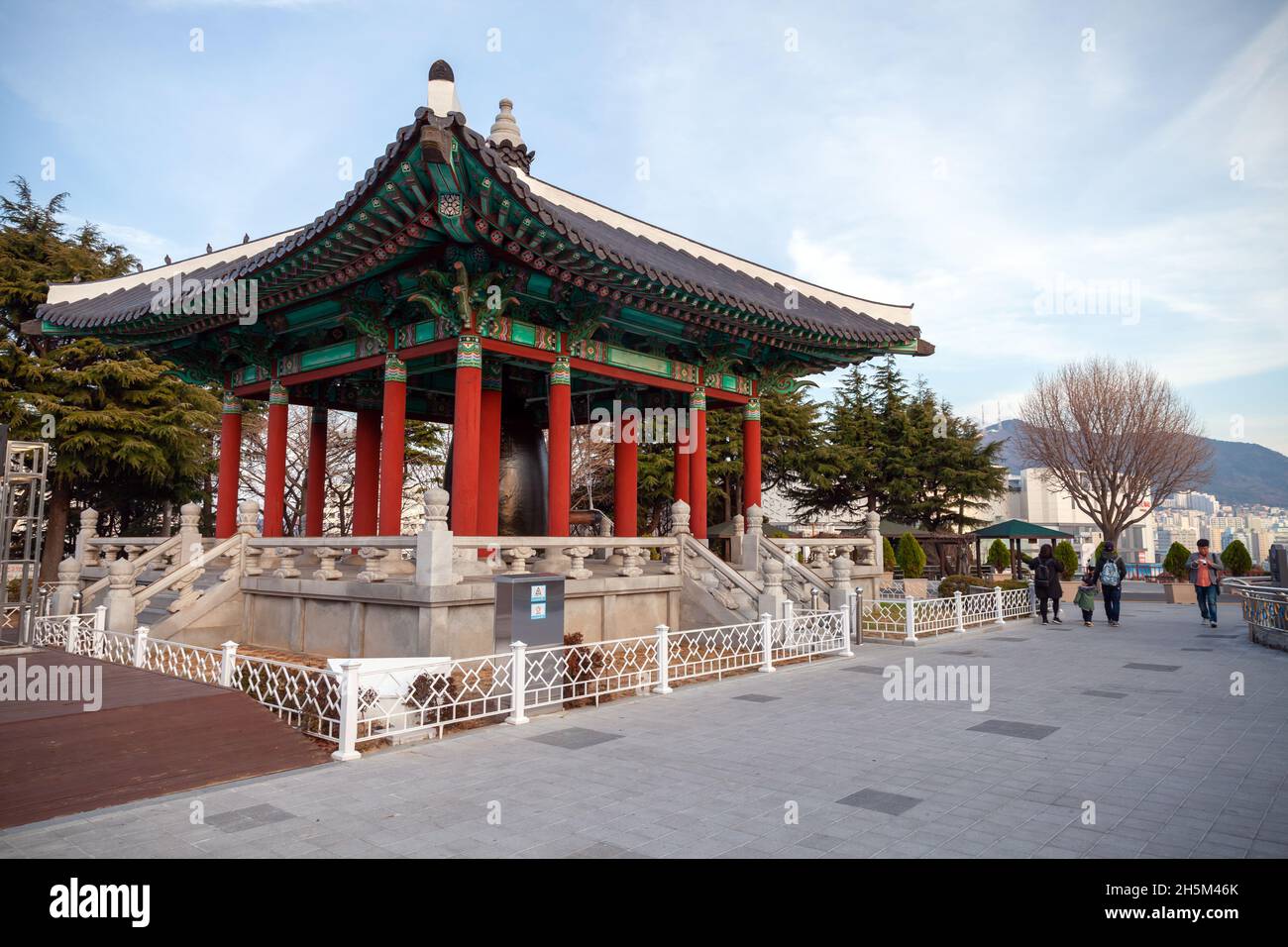 Busan, South Korea - March 14, 2018: The bell pavilion located at Yongdusan Park, tourists walk nearby Stock Photo
