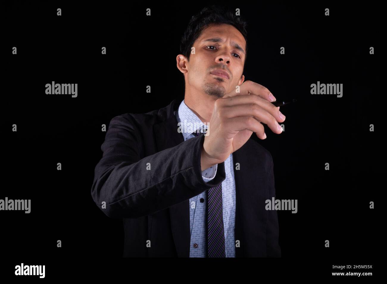 Businessman writing in the air. Young businessman drawing, pointing or