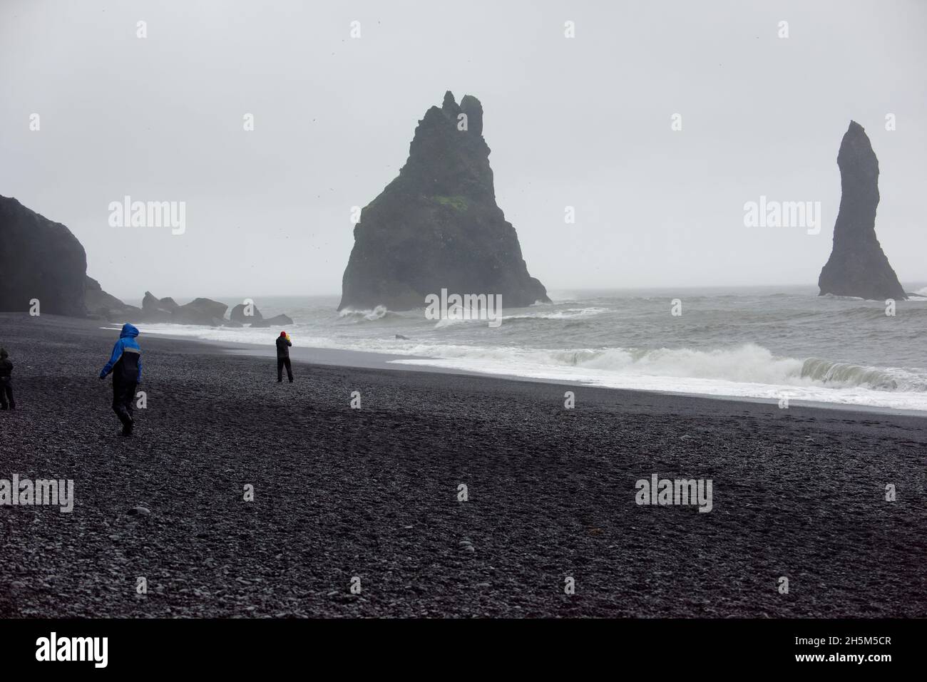 The Reynisdrangar basalt sea stacks and the Reynisfjara black sand ...