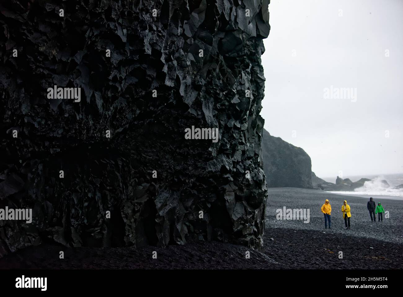 The Reynisdrangar basalt sea stacks and the Reynisfjara black sand ...