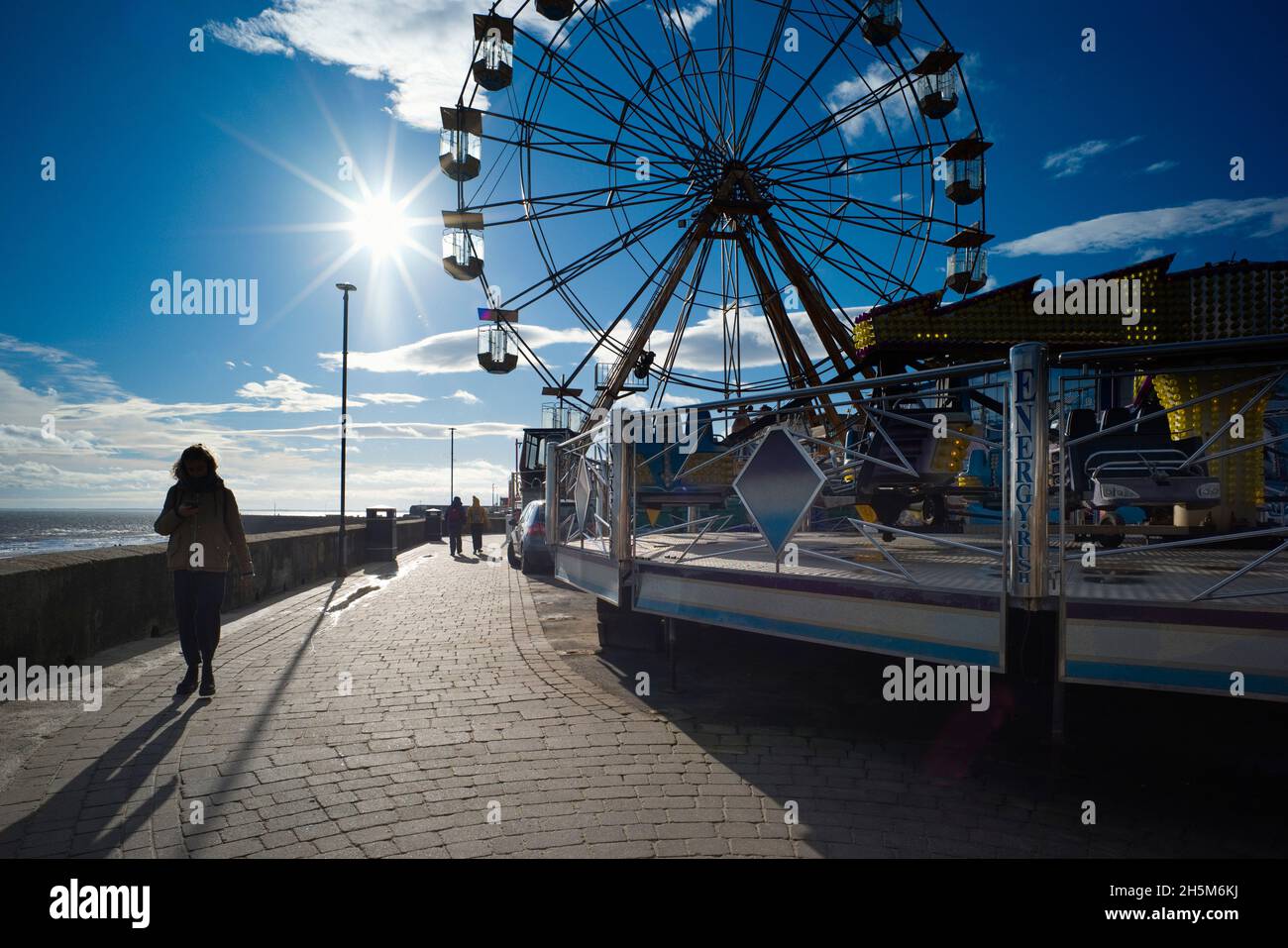 Big wheel and funfair against the light at Bridlington, East Riding Stock Photo