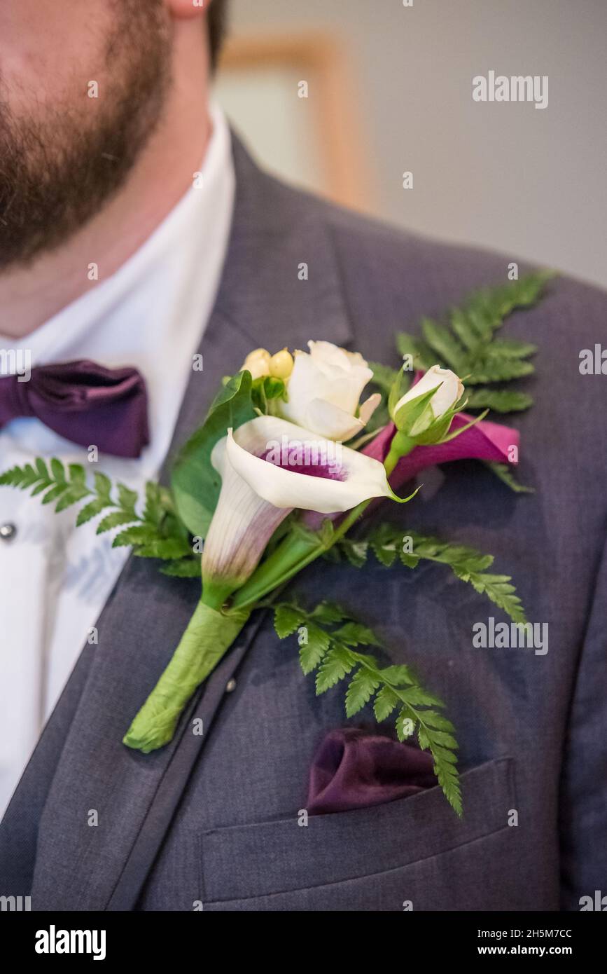 Vertical close up shot of handmade bridal flower brooch on groom suit Stock  Photo - Alamy