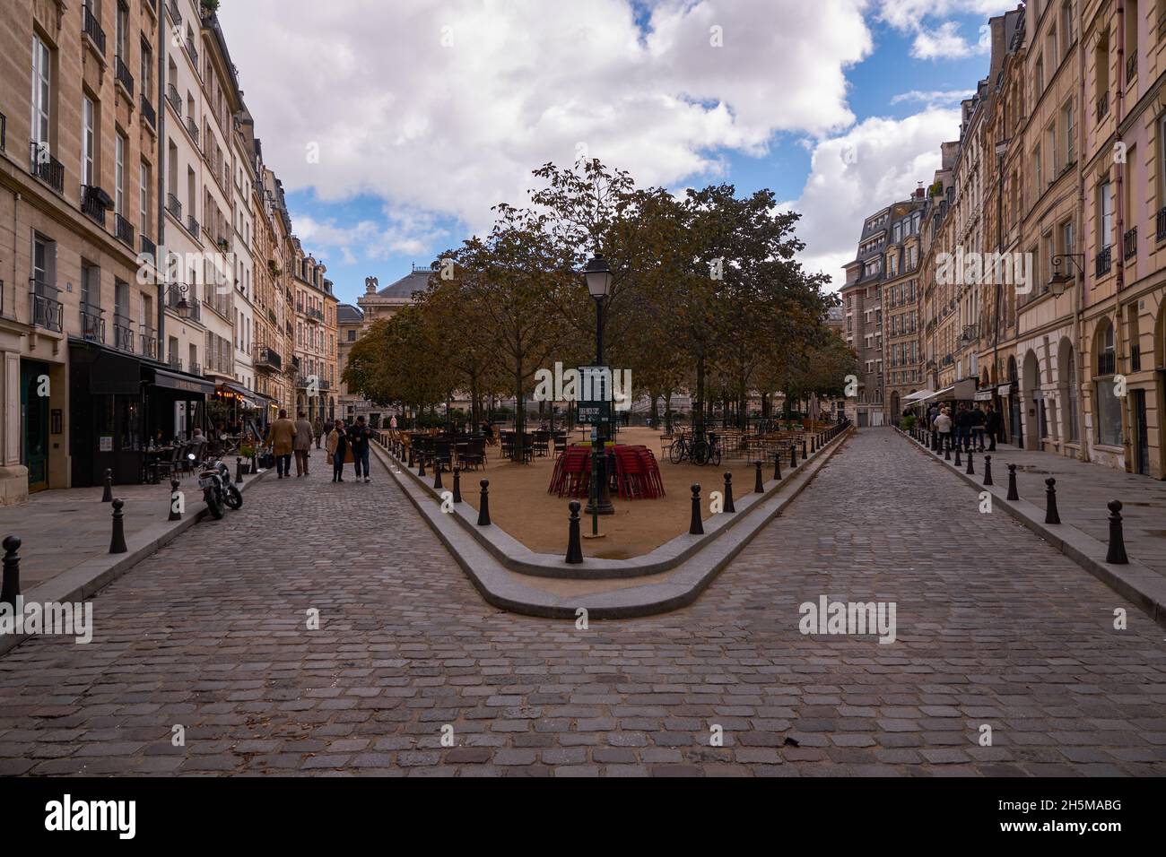 Beautiful Tradional and Old Parisian Bulding Facades with Red and White Bricks in Place Dauphine - Paris, France - Île de la Cité Stock Photo