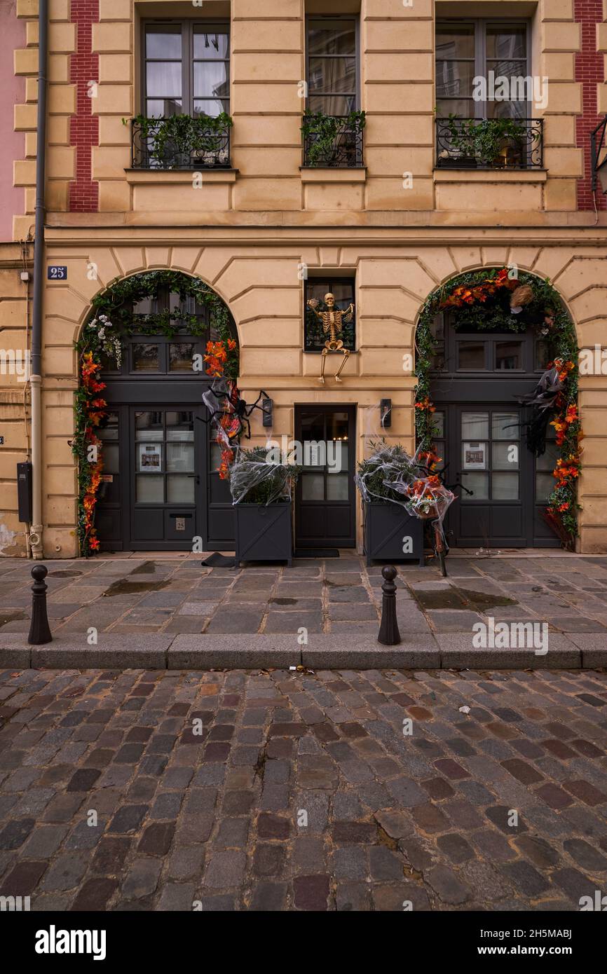 Halloween Decorations in a Storefront ith Pumpkins and a Skeleton
