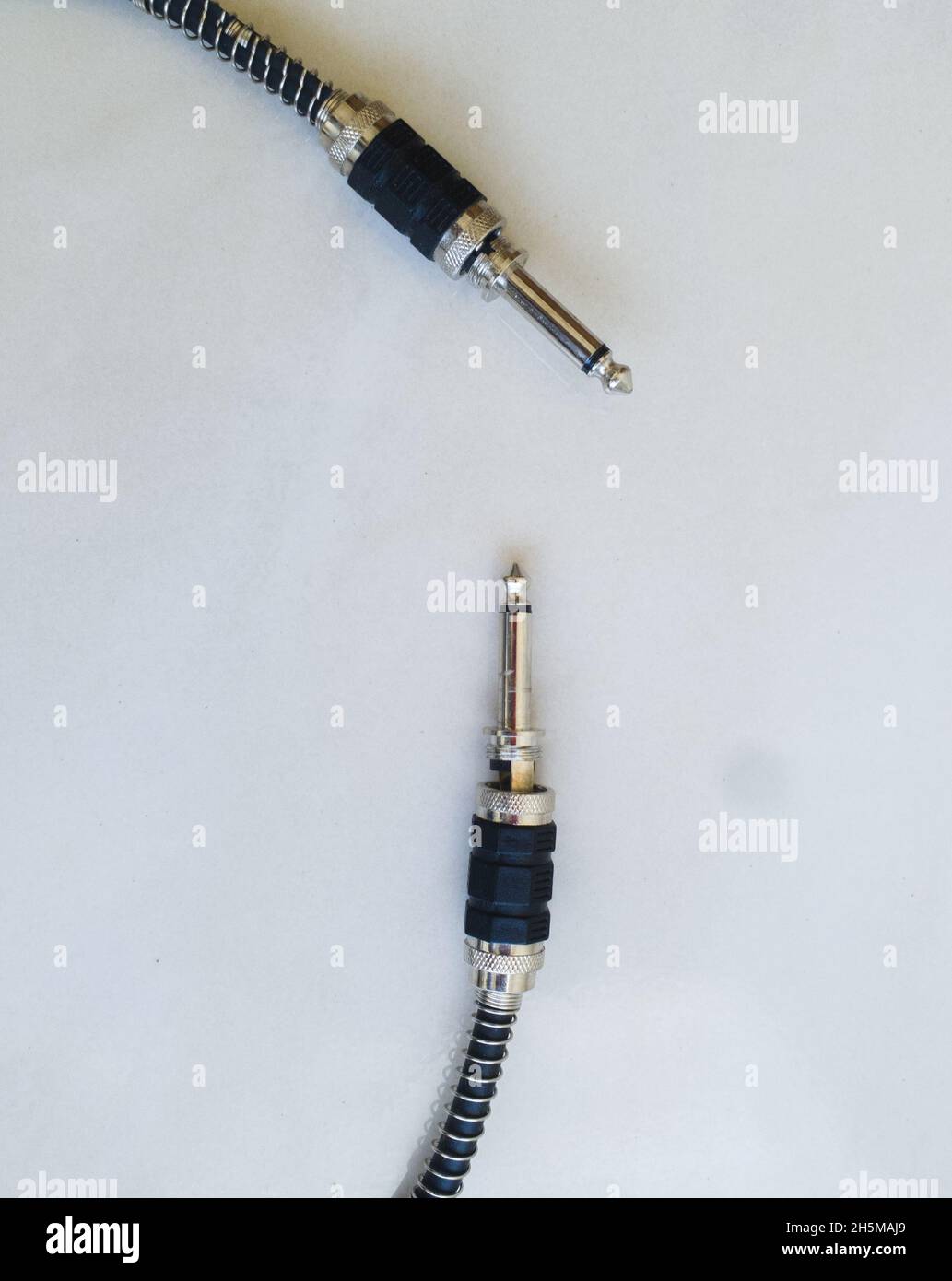 Vertical top view of two shift cables on a white surface Stock Photo