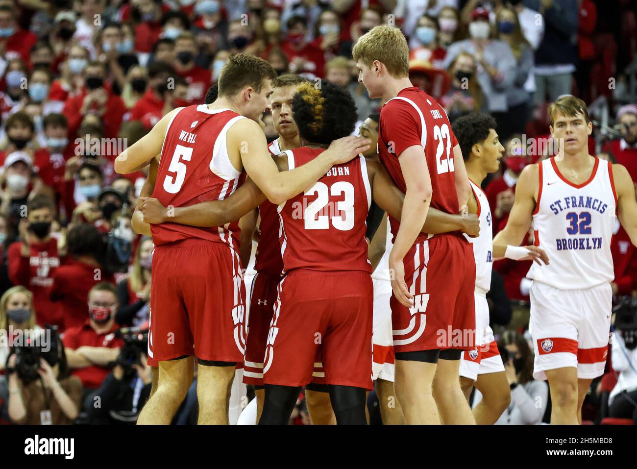 November 09, 2021: Wisconsin Badgers guard Chucky Hepburn (23), forward Tyler Wahl (5), forward Steven Crowl (22), and guard Brad Davison (34) huddle up during the NCAA Basketball game between the St. Francis Terriers and the Wisconsin Badgers at the Kohl Center in Madison, WI. Darren Lee/CSM Stock Photo