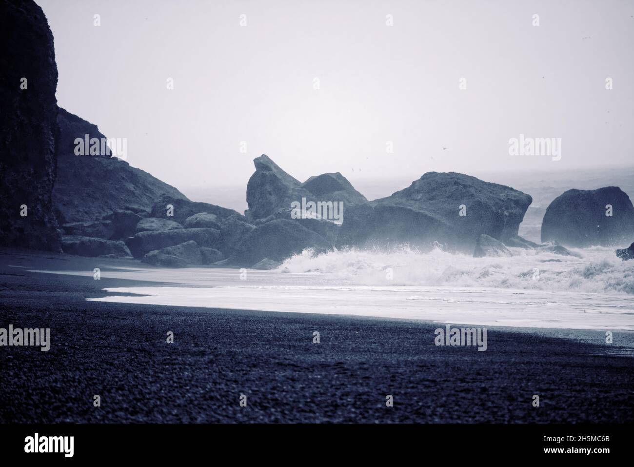The Reynisdrangar basalt sea stacks and the Reynisfjara black sand ...