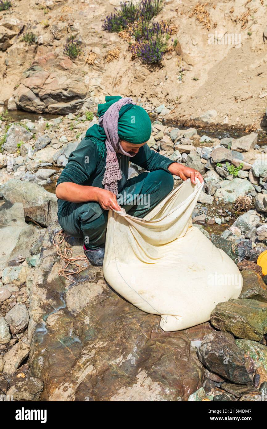 Rabot, Gorno-Badakhshan Autonomous Province, Tajikistan. August 14, 2021. Churning milk into butter in rural Tajikistan. Stock Photo