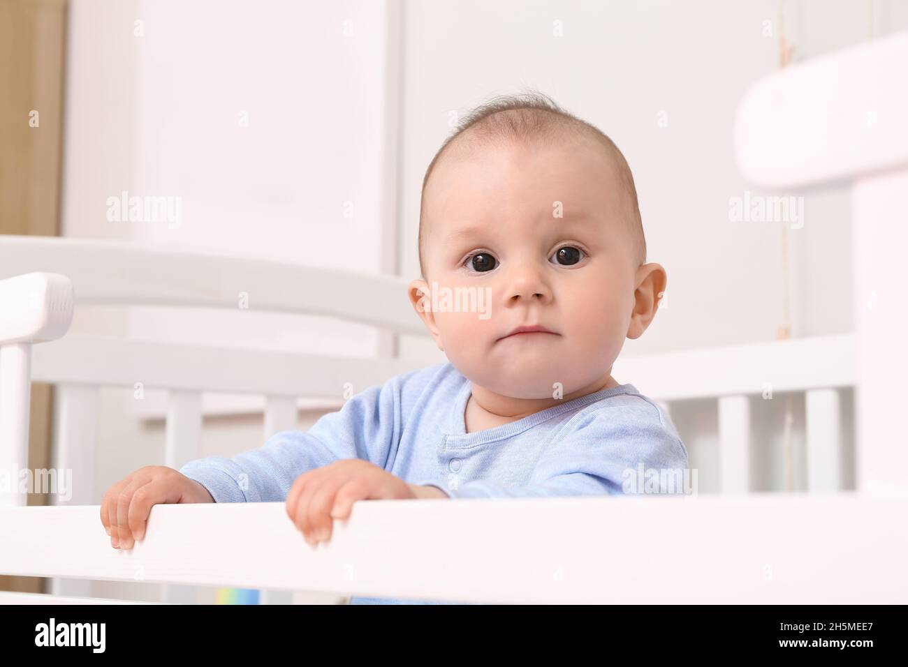 Cute little baby boy in crib Stock Photo Alamy