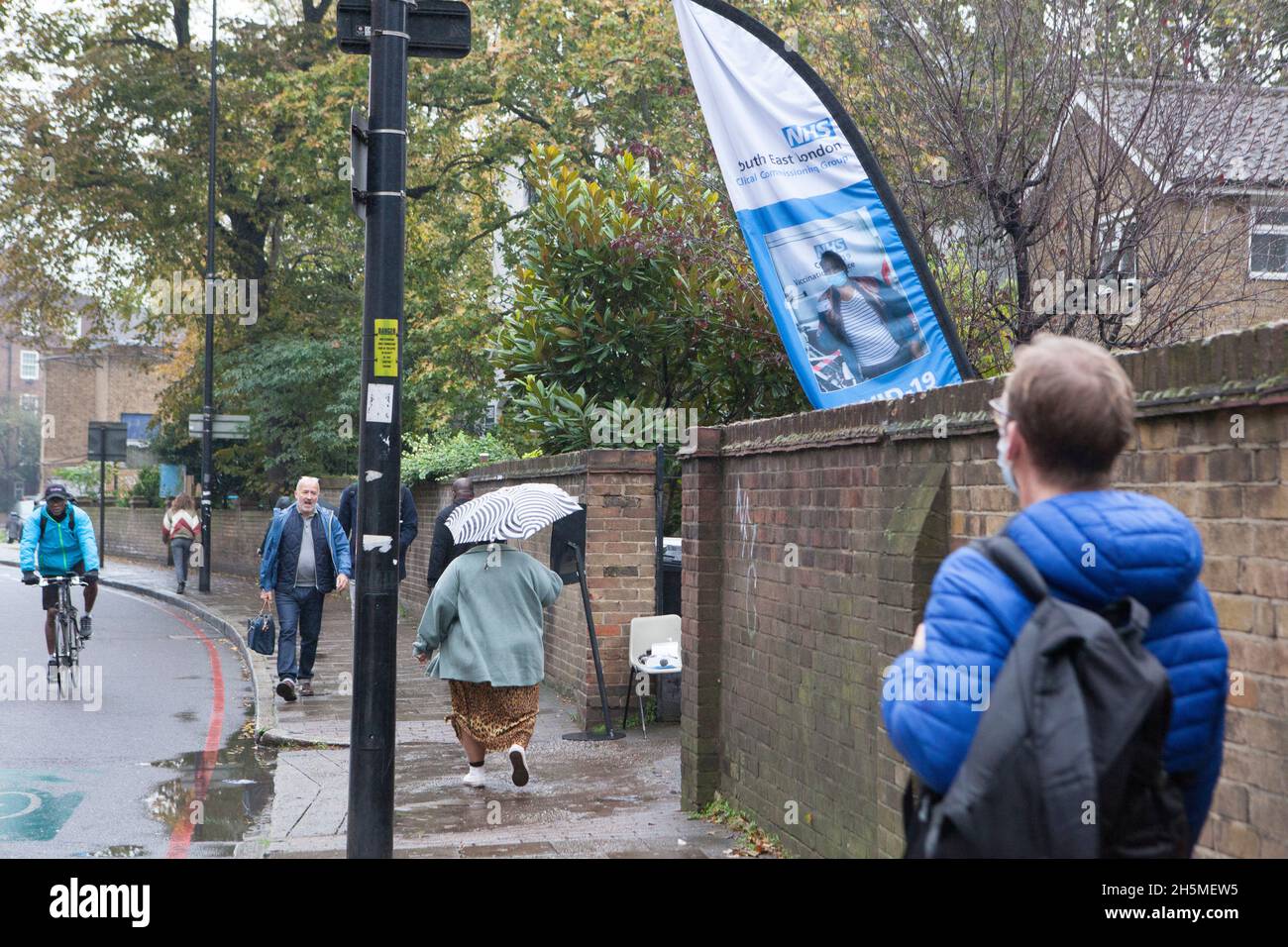 London, UK, 10 November 2021: at a vaccination centre next to Kennington Oval cricket ground a steady stream of people attend to get their booster jabs or first jabs of Pfizer coronavirus vaccine. Anna Watson/Alamy Live News Stock Photo