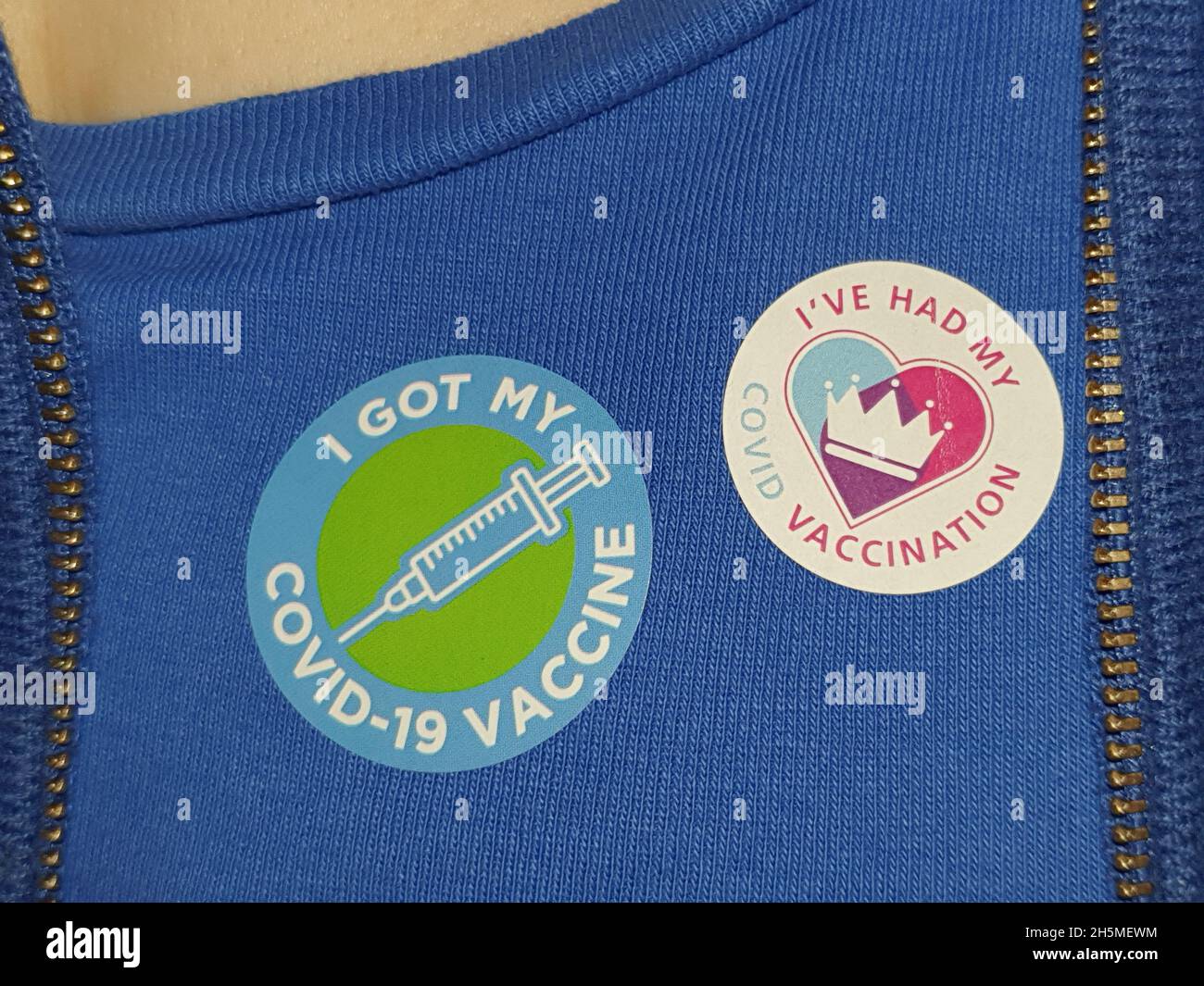 London, UK, 10 November 2021: at a vaccination centre next to Kennington Oval cricket ground a steady stream of people attend to get their booster jabs or first jabs of Pfizer coronavirus vaccine. After the vaccination there is the gift of a sticker, to encourage others to get their vaccine too. Anna Watson/Alamy Live News Stock Photo