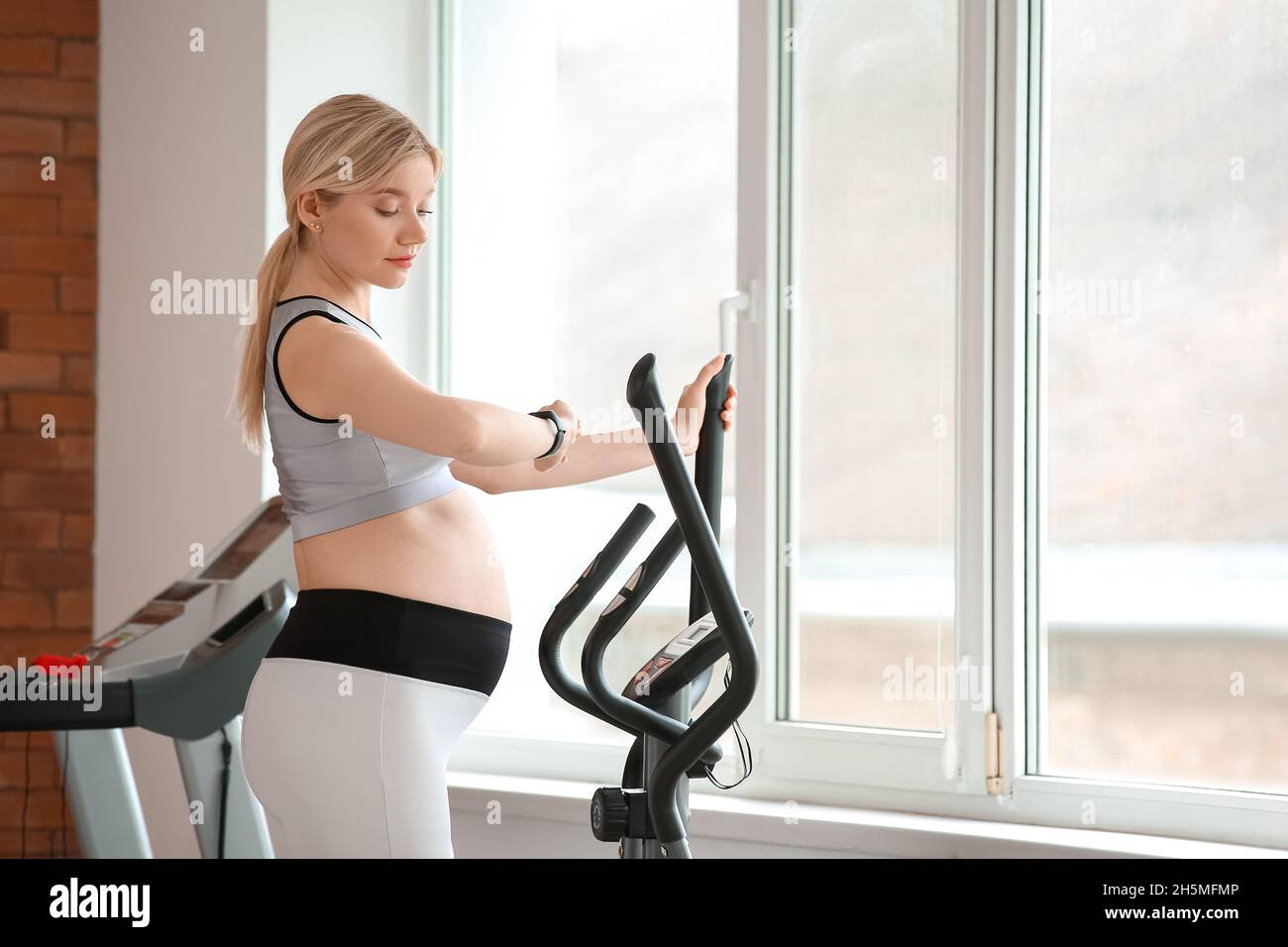Young pregnant woman training with stair stepper in gym Stock Photo Alamy