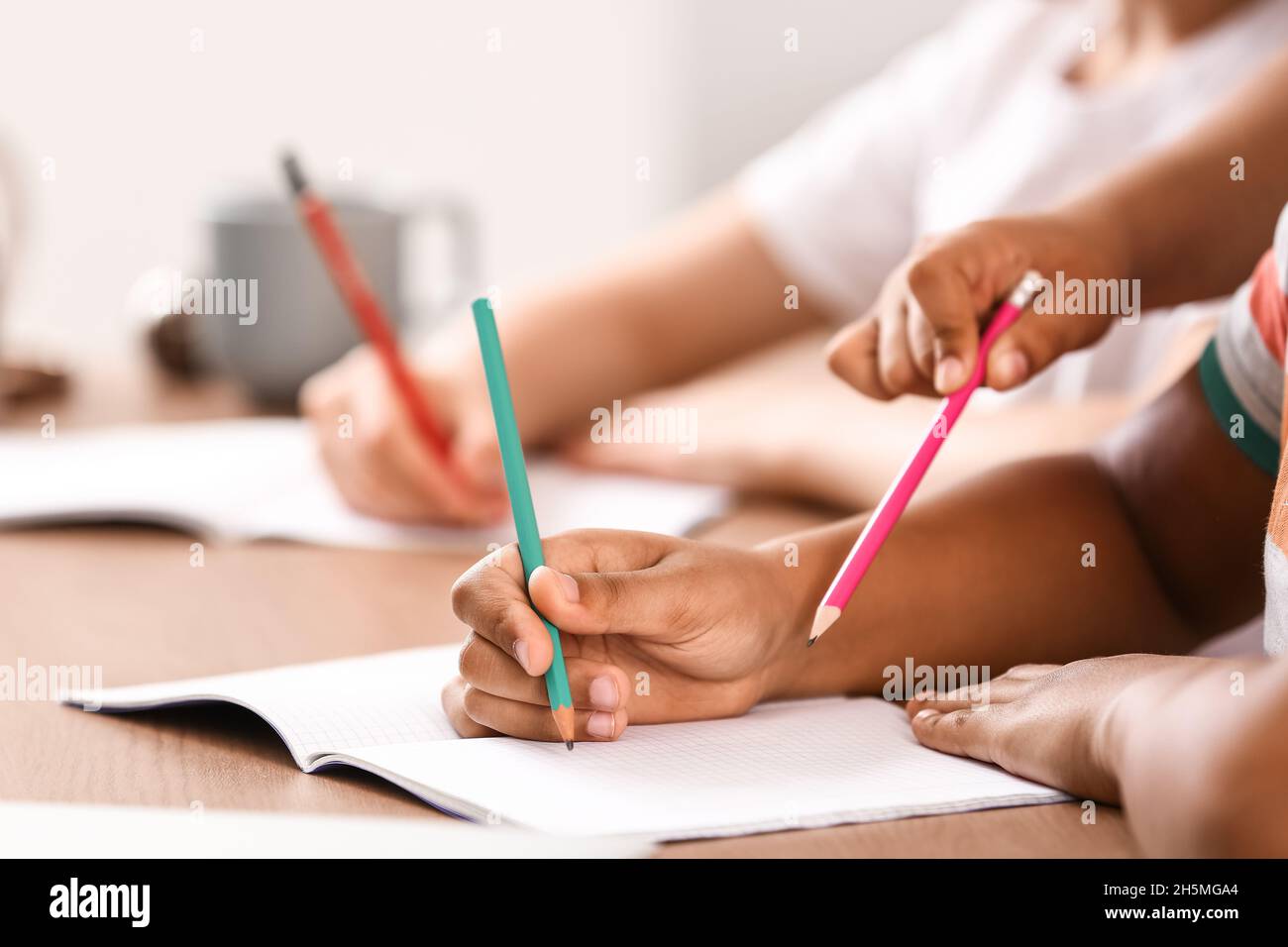 Little pupils studying at home, closeup Stock Photo