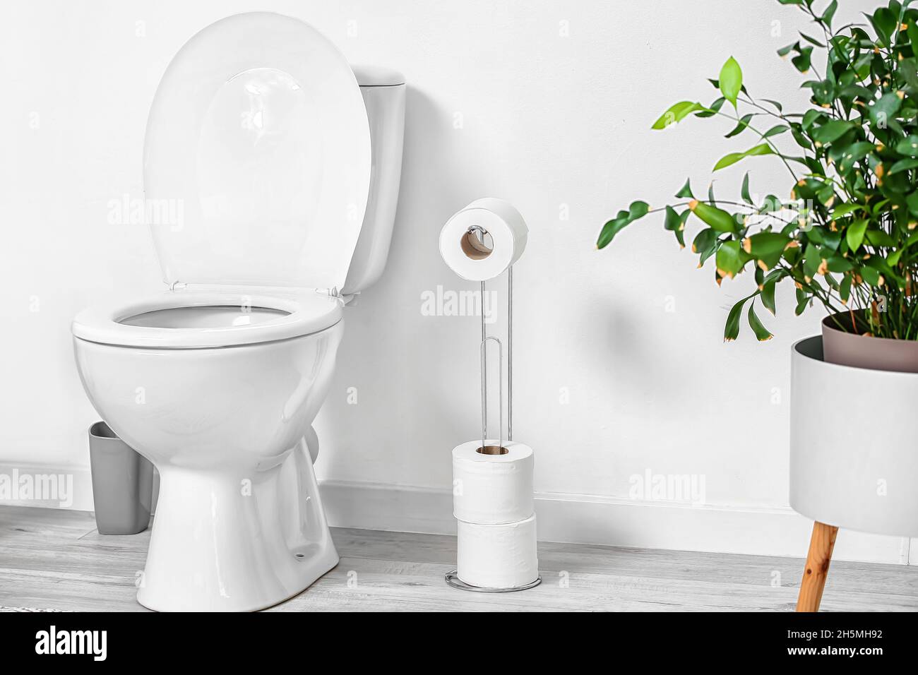 Interior of modern restroom with toilet bowl Stock Photo - Alamy