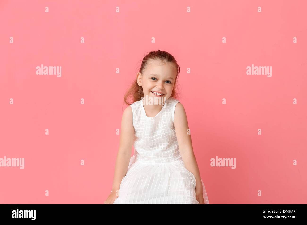 Portrait of pretty little girl on color background Stock Photo - Alamy