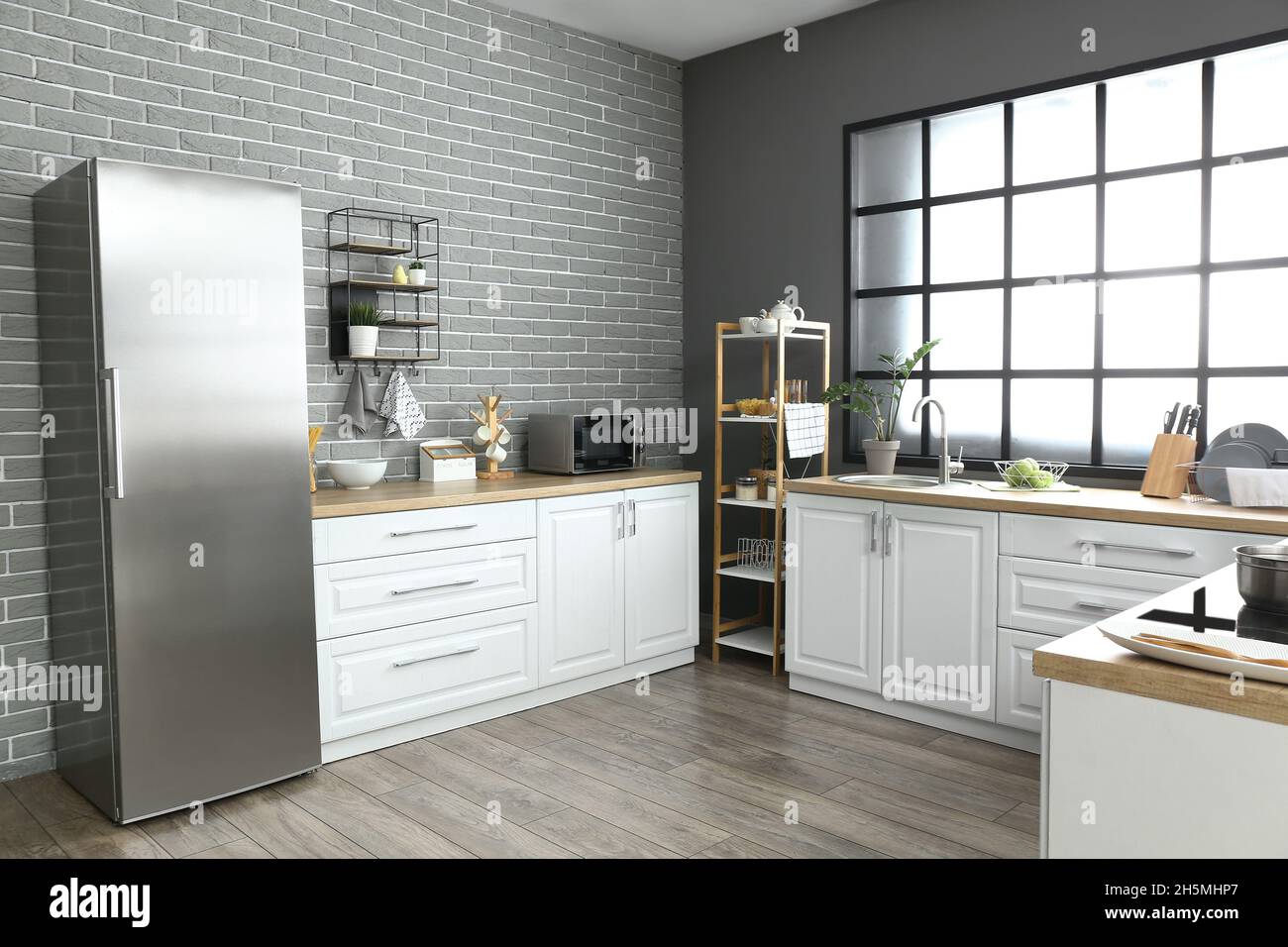 Interior of modern kitchen with fridge and white counters Stock Photo ...