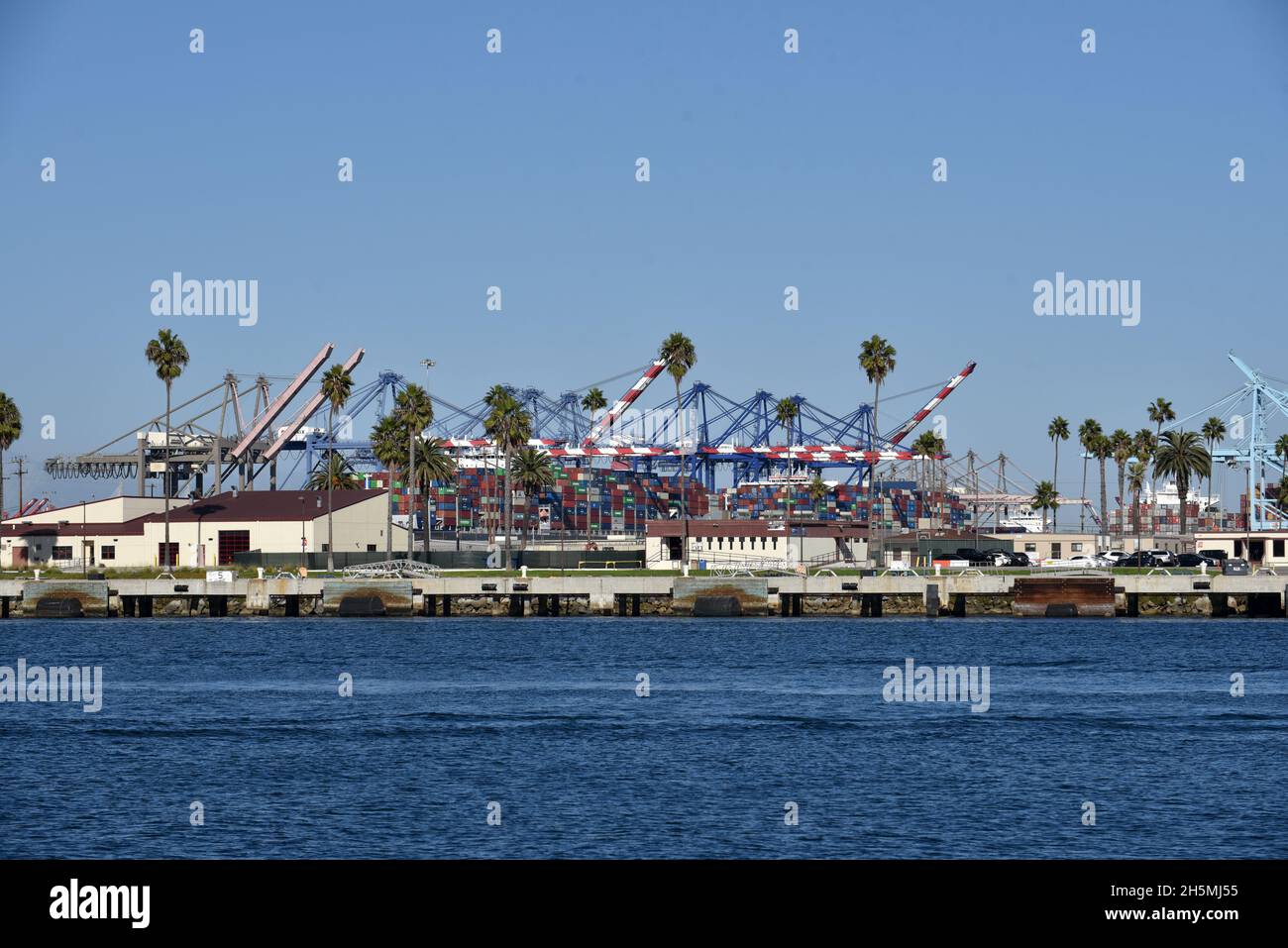 Los Angeles, CA USA - October 15, 2021: Shipping containers and gantry cranes in the main channel of the Port of Los Angeles on a beautiful summer day Stock Photo
