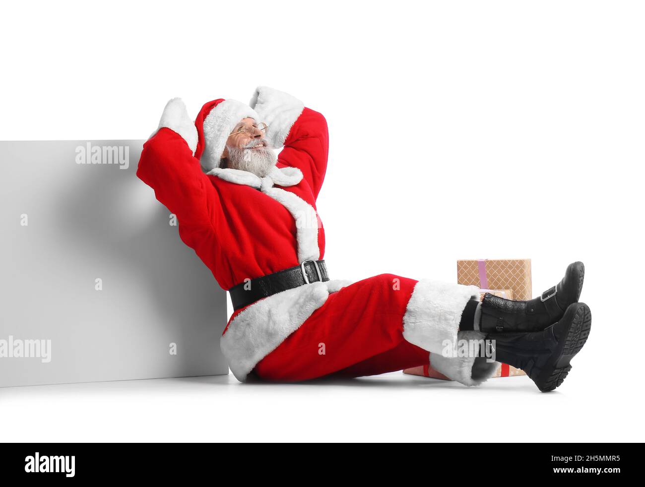 Santa Claus with blank poster and gift boxes on white background Stock ...