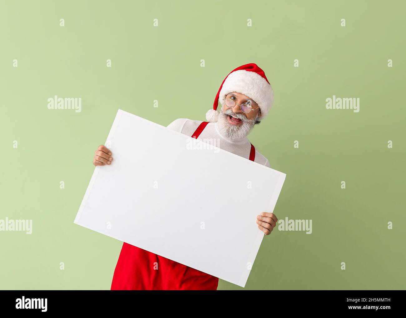 Santa Claus with blank poster on color background Stock Photo - Alamy