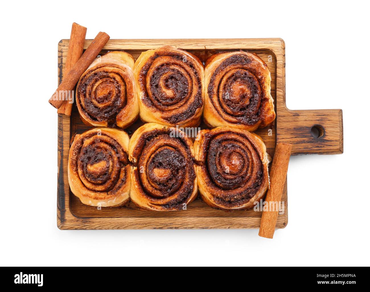 Wooden board with tasty cinnamon rolls on white background Stock Photo ...