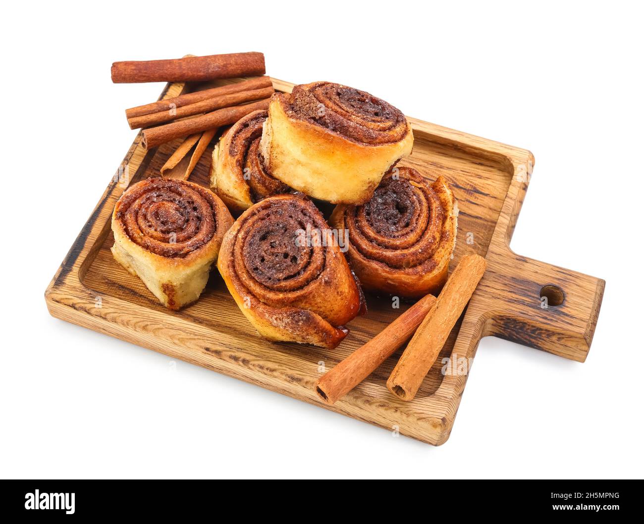 Wooden board with tasty cinnamon rolls on white background Stock Photo ...