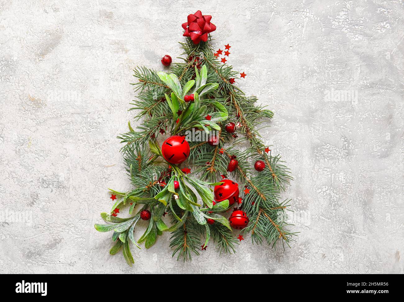 Tree made of fir branches and Christmas decor on light background Stock ...