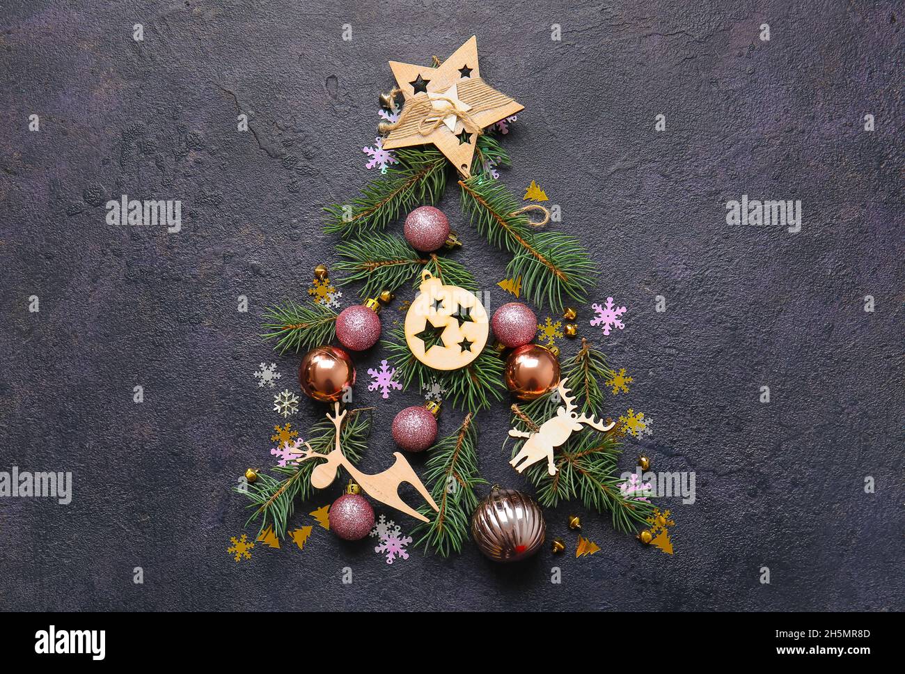 Tree made of fir branches and Christmas decor on dark background Stock ...