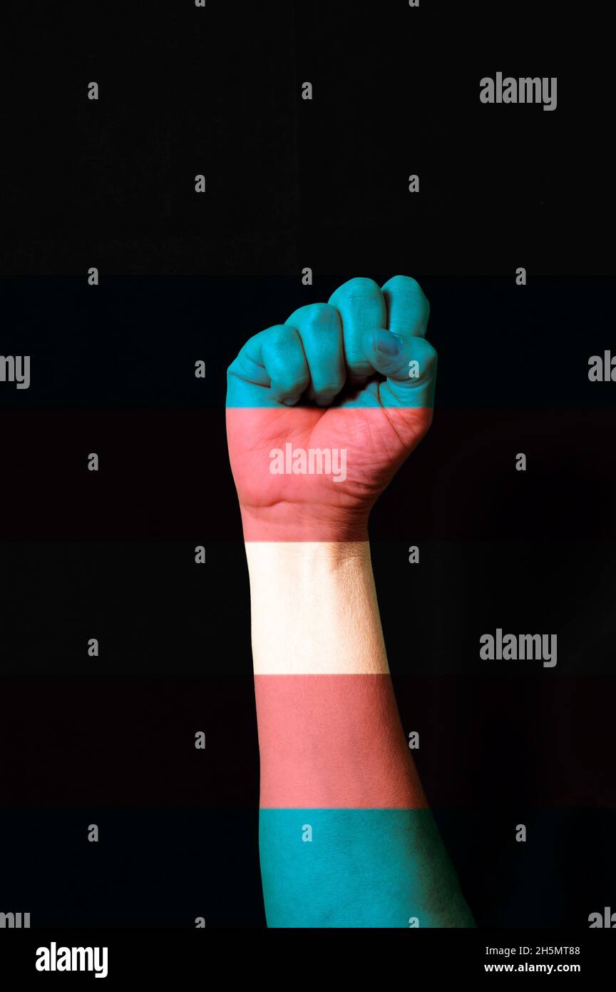 Fist hand with transgender pride flag patterned isolate on black. LGBTQ+ rights concept Stock Photo