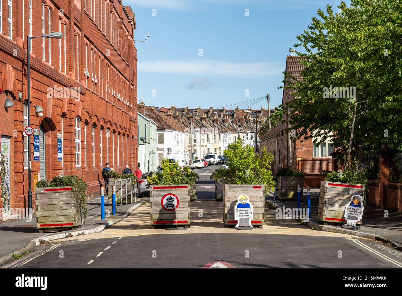 A street outside a primary school is closed to motor traffic using flower planters to create a 'modal filter' in Southville, Bristol. Stock Photo