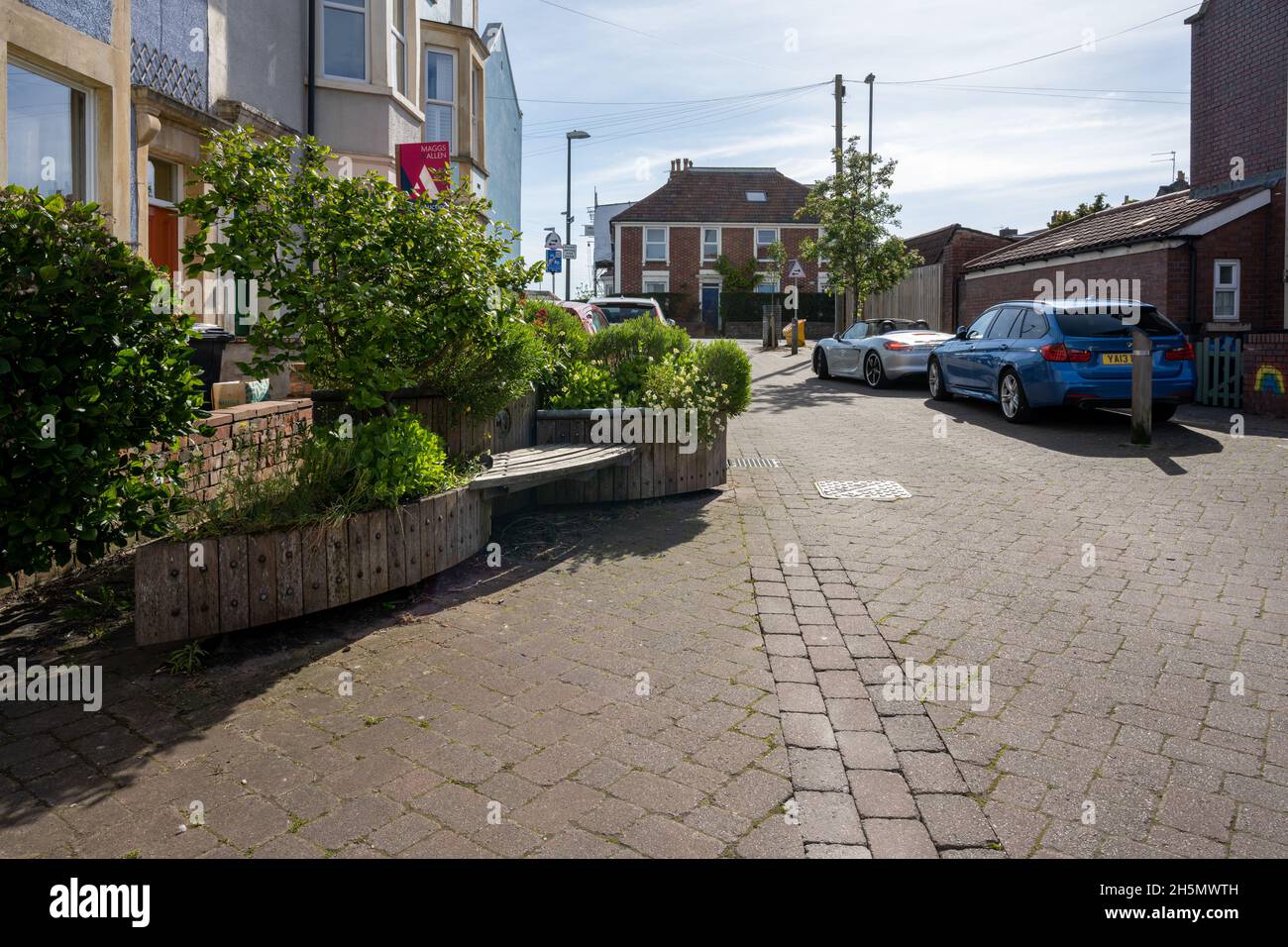 Benches, flower planters and a shared surface are designed to reduce traffic speeds and dominance in Milford Street 'Home Zone' in Southville, Bristol Stock Photo