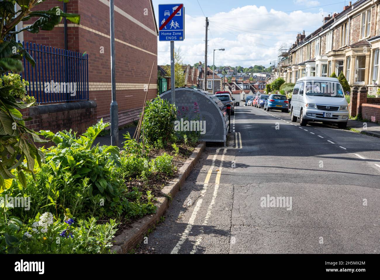 A planting border and a secure cycle parking 'Bike Hangar' contribute to traffic calming in a 'Home Zone' residential street in Bristol. Stock Photo