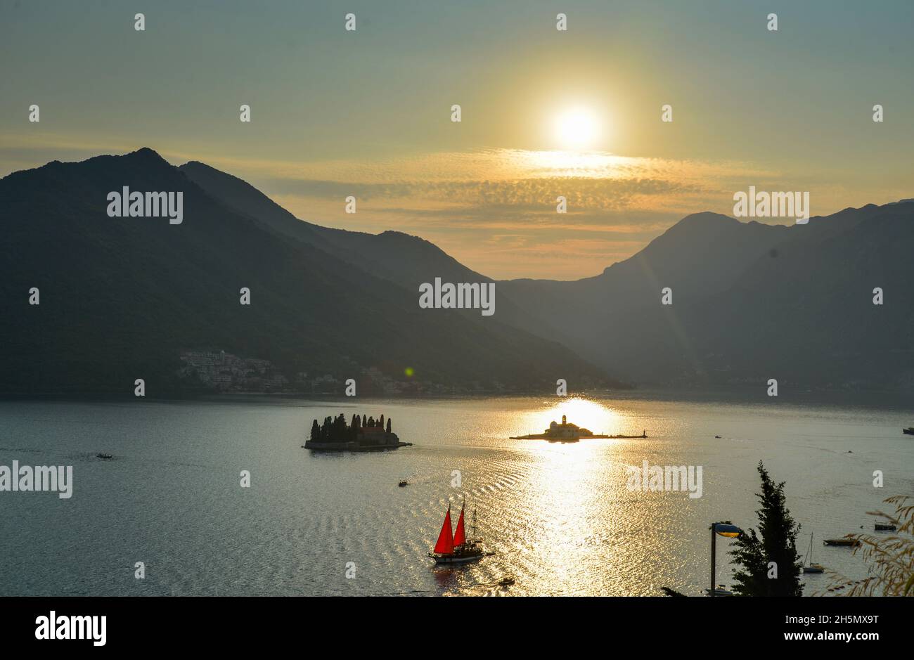 In the late summer sun, its sails glow in the backlight as it drifts by St Georges Island along the coast of this popular tourist destination. Stock Photo