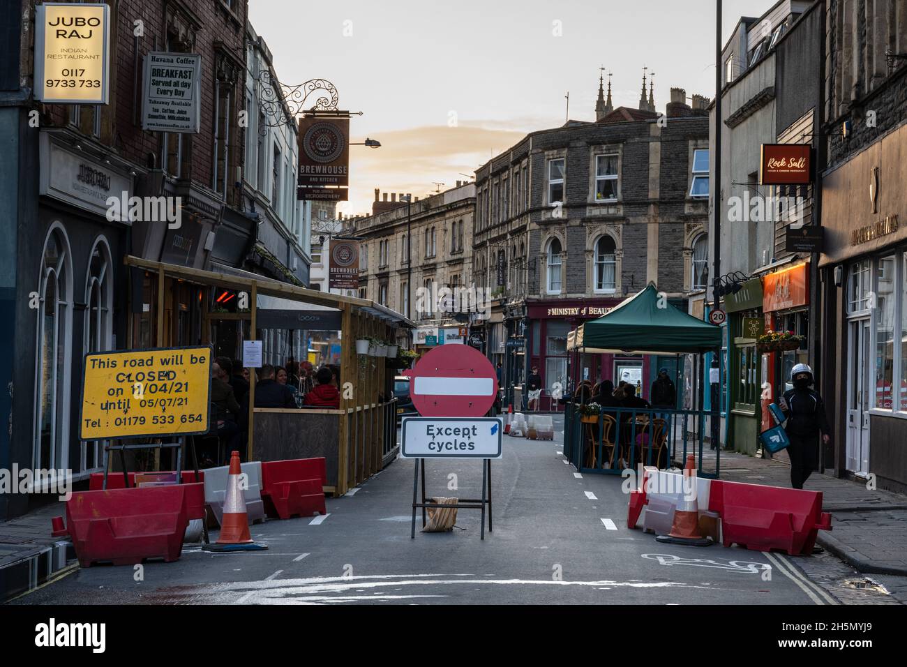 A street is closed to traffic making space for al fresco dining outside restaurants and bars during the Covid-19 pandemic in Bristol. Stock Photo