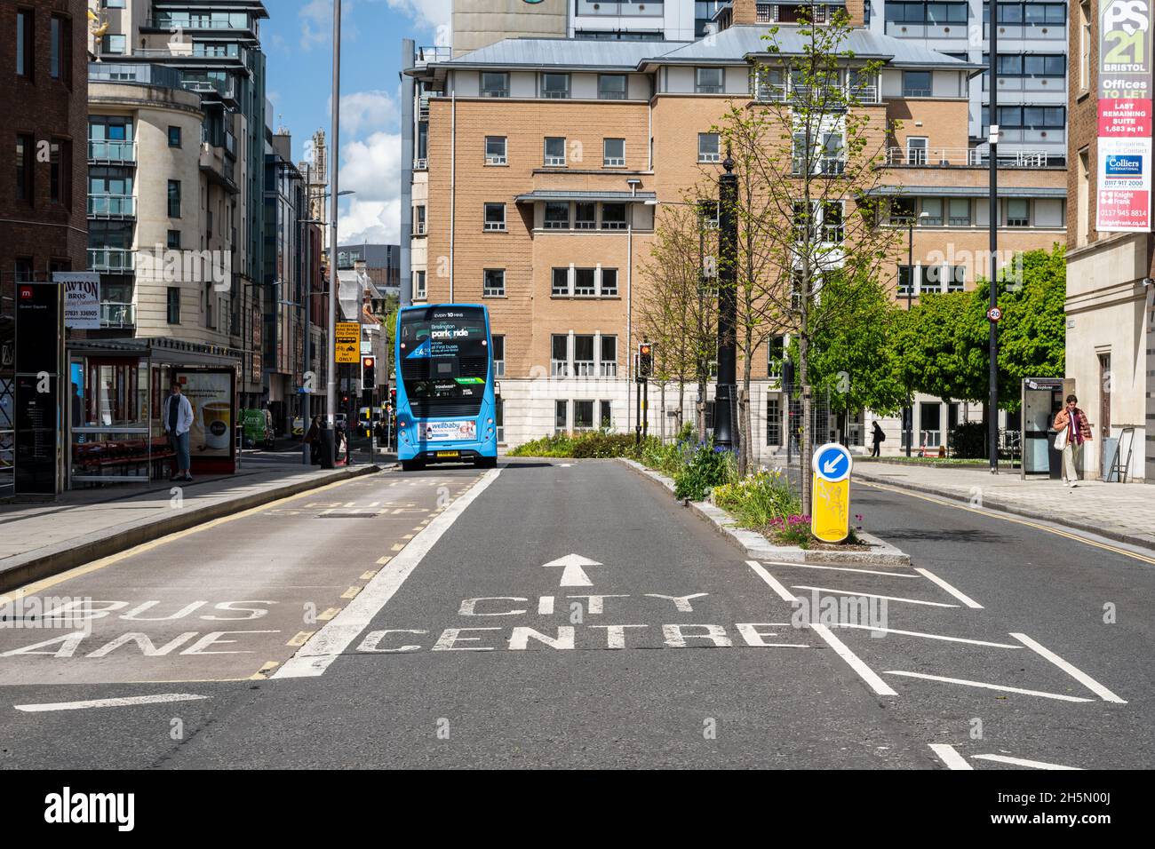 Newly planted street trees and flowers fill a traffic calming island on a main bus route in central Bristol. Stock Photo