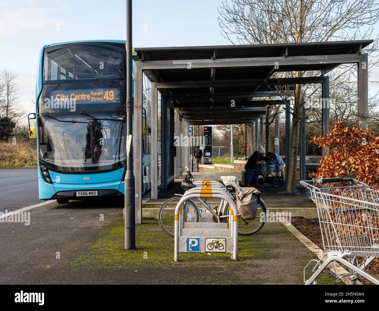 A double-decker bus waits at the new bus terminus in Lyde Green, a new build suburb on the northern fringe of Bristol. Stock Photo