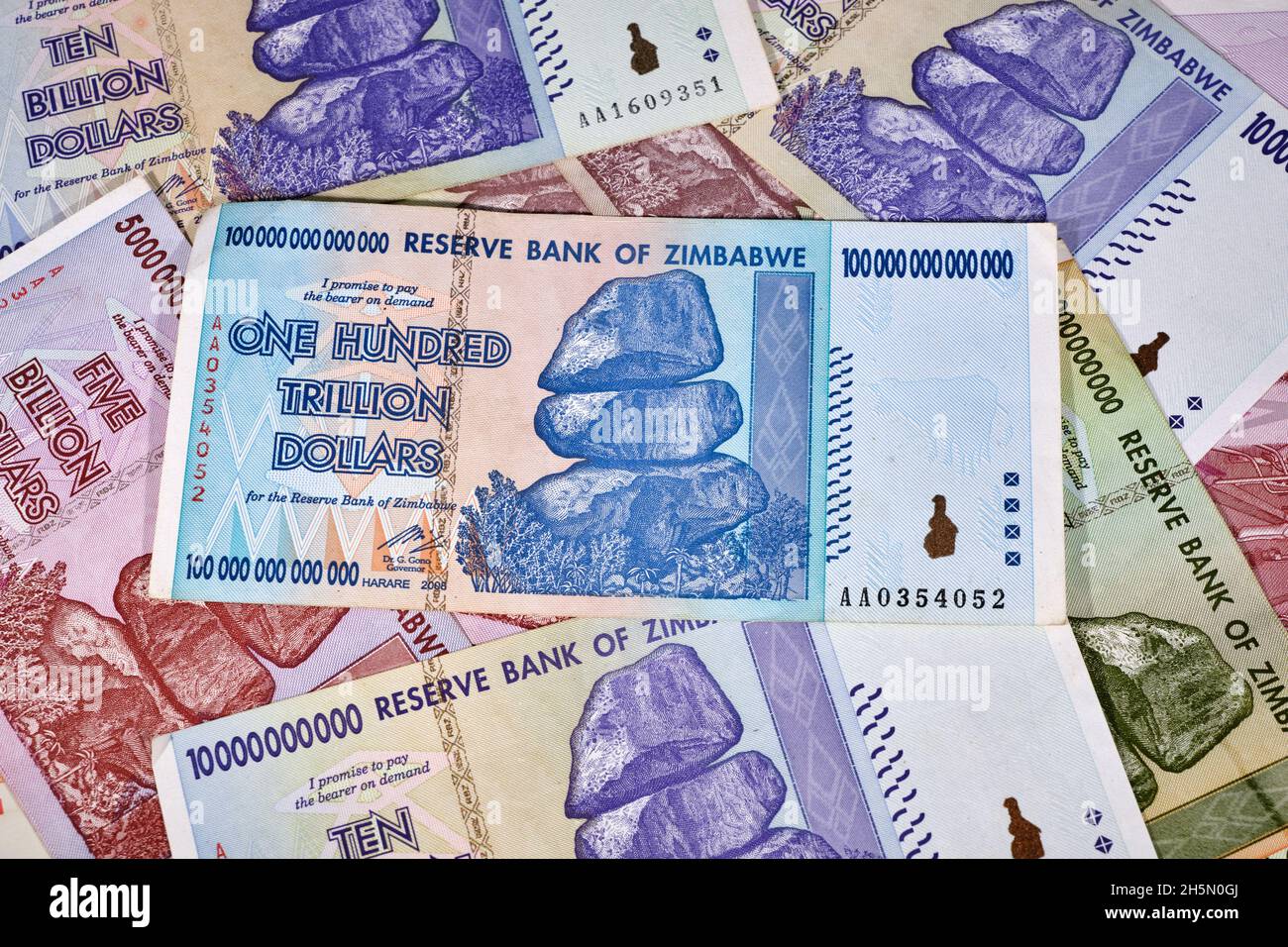 Lot of Zimbabwe hyper inflation dollar bills including the One Hundred Trillion Dollars, the currency is now worthless money Stock Photo