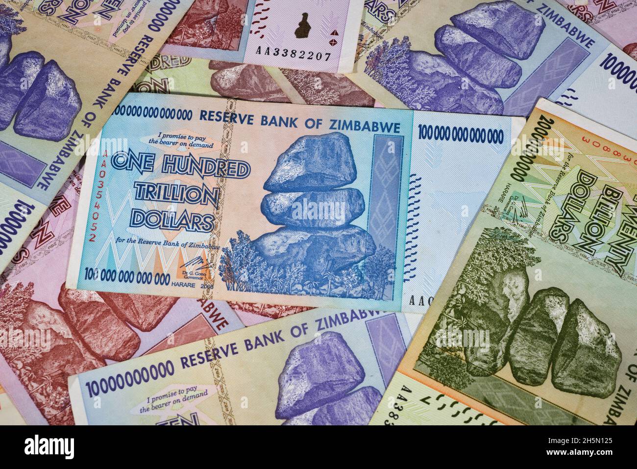 Lot of Zimbabwe hyper inflation dollar bills including the One Hundred Trillion Dollars, the currency is now worthless money Stock Photo