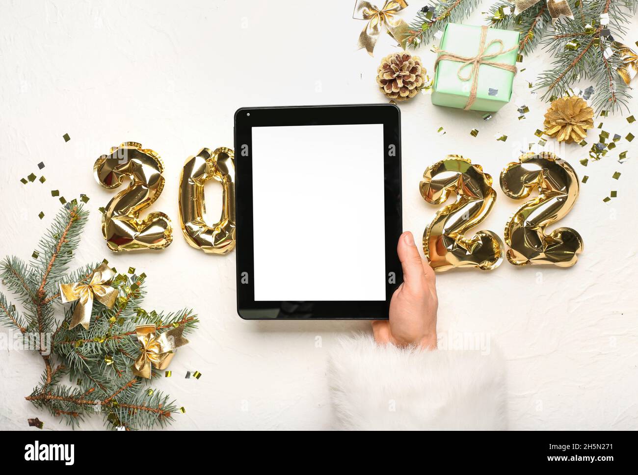 Christmas 2022 Tablets Santa Claus With Tablet Computer And Balloons In Shape Of Figure 2022 On  White Background Stock Photo - Alamy