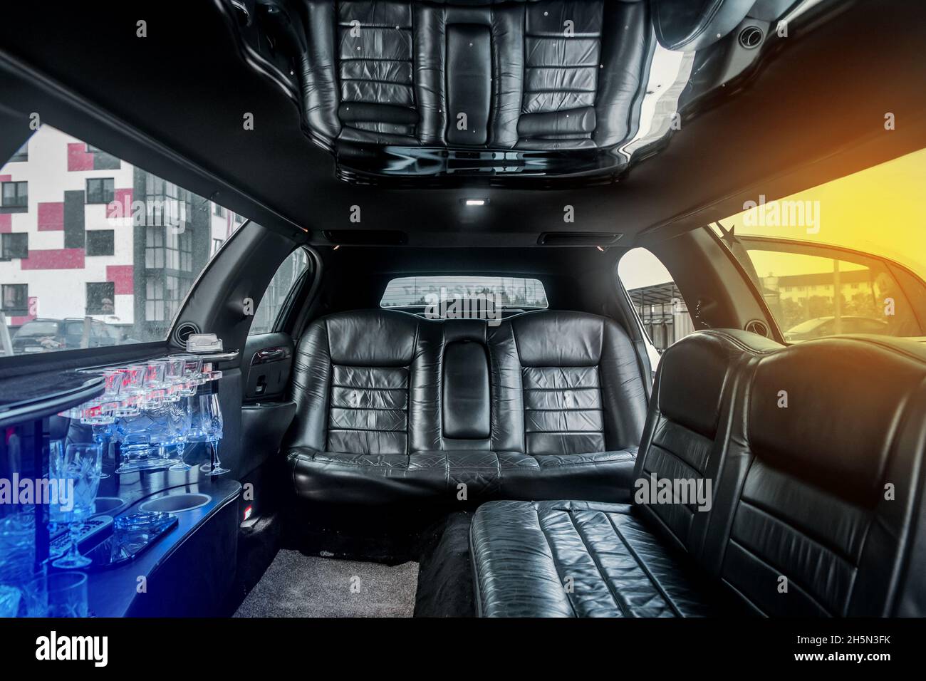 Luxury car interior limousine with black leather seats and a small bar inside the interior of the car. Stock Photo