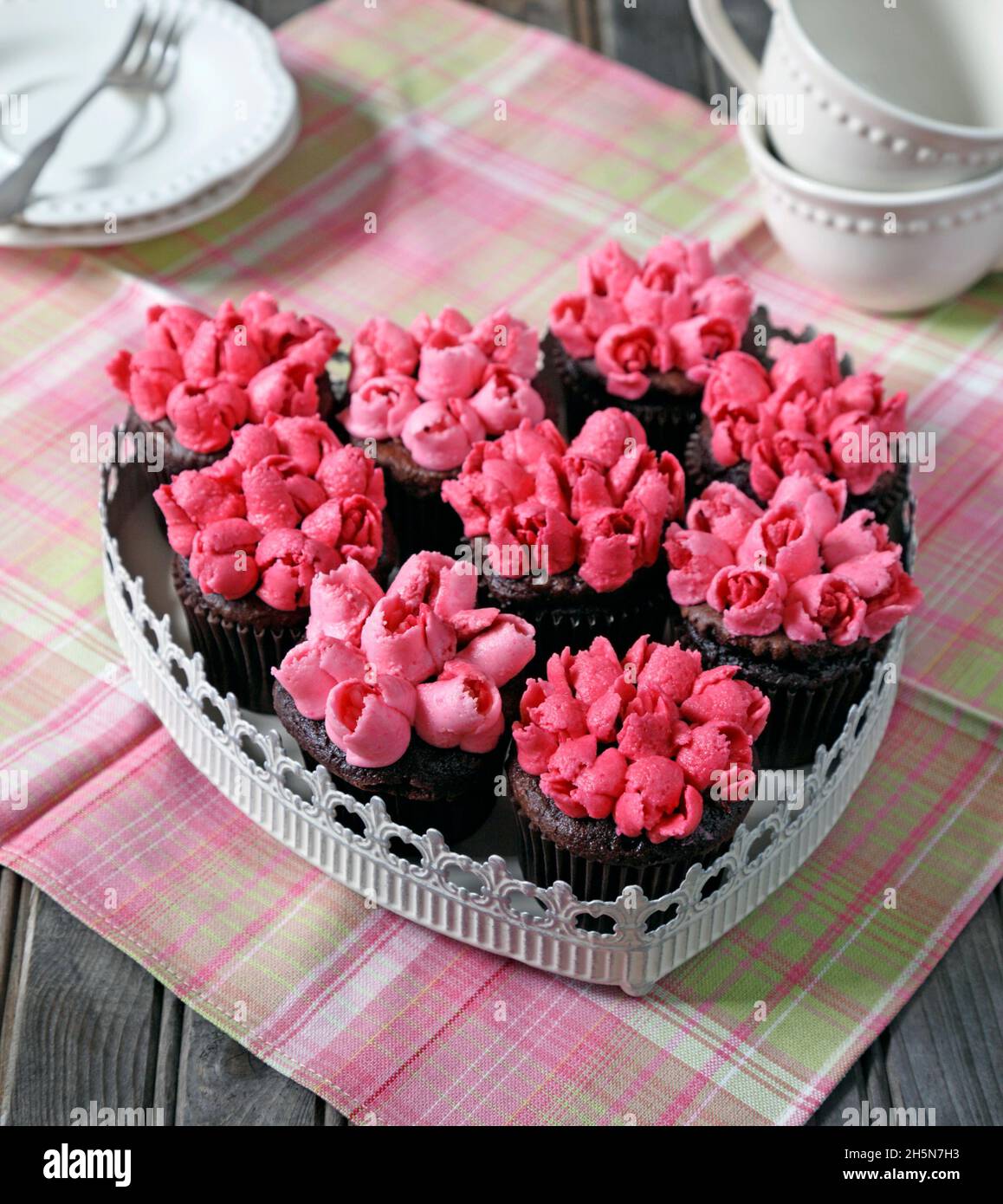 Dark chocolate cupcakes decorated with pink Tulips using Russian piping tip Stock Photo