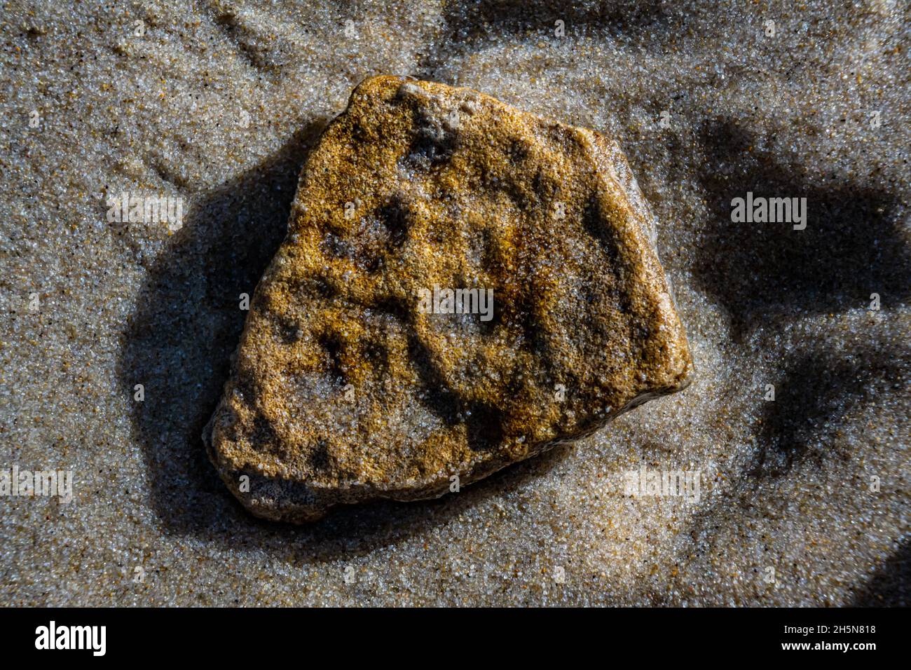 close up of stone washed up on beach (macro) Stock Photo