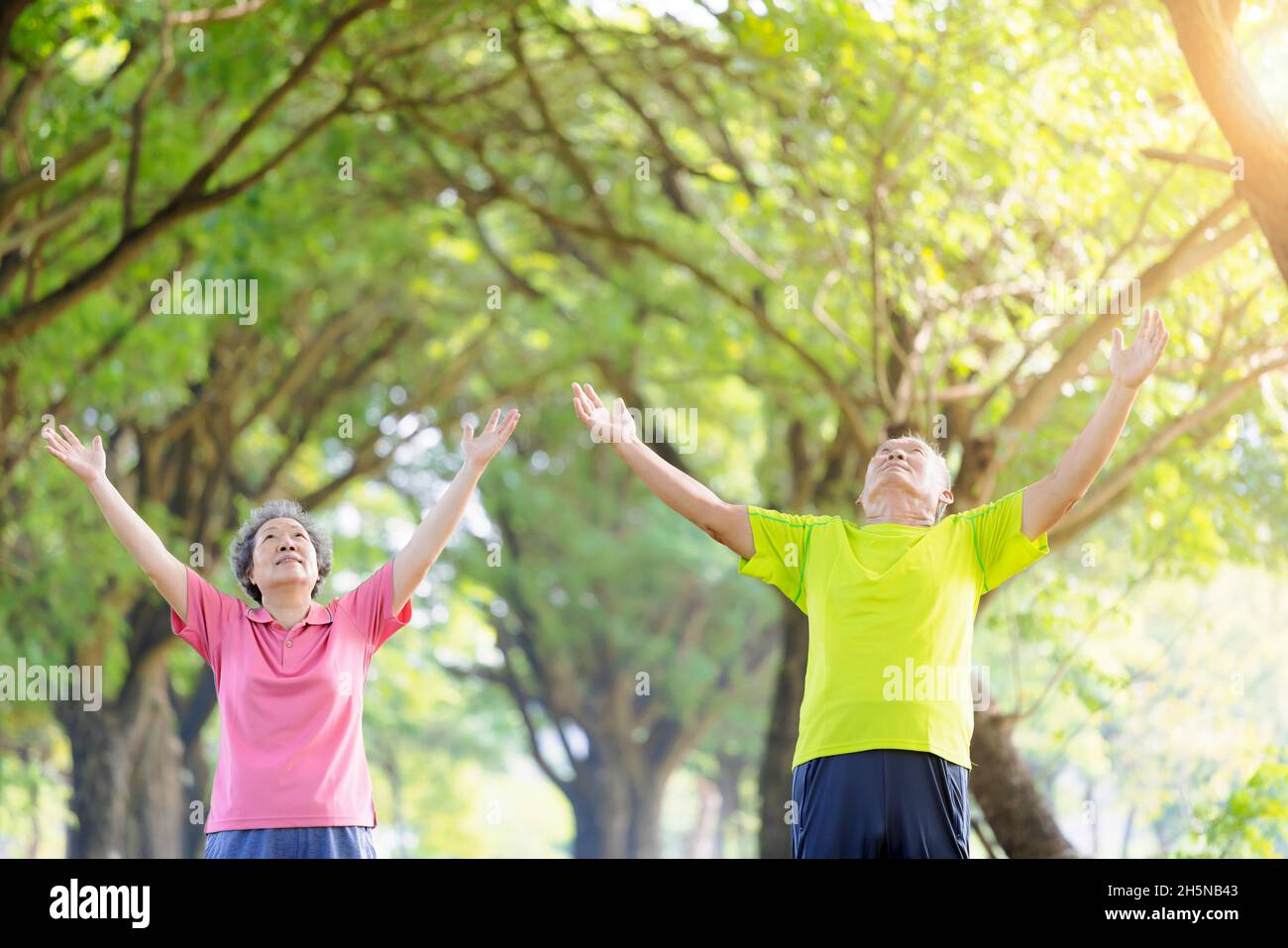 Senior couple taking a deep breath in the park Stock Photo