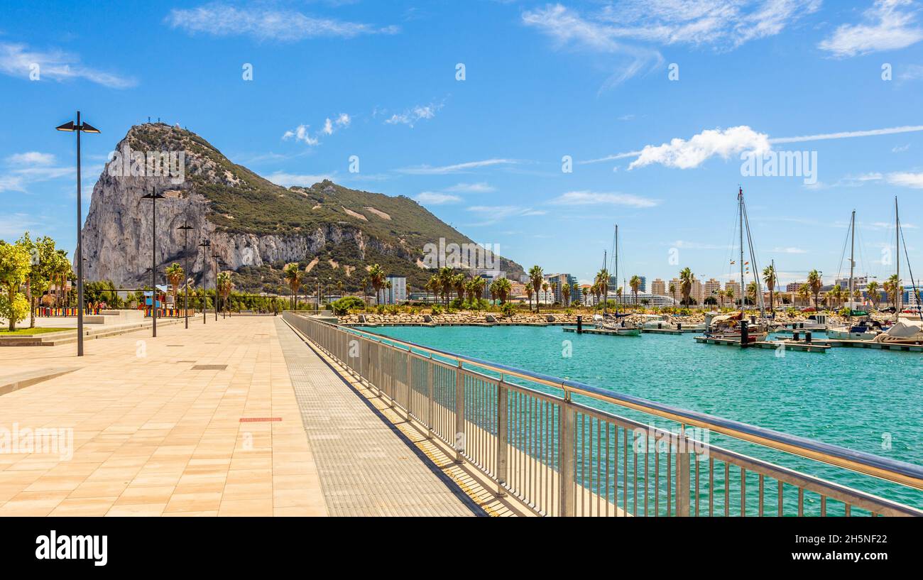 Road to the Rock of Gibraltar with marina on the left and town behind, view from La Linea, Spain Stock Photo